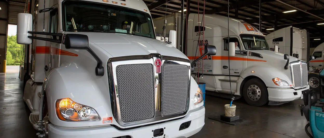 photos of various trucks and drivers smiling inside truck cab