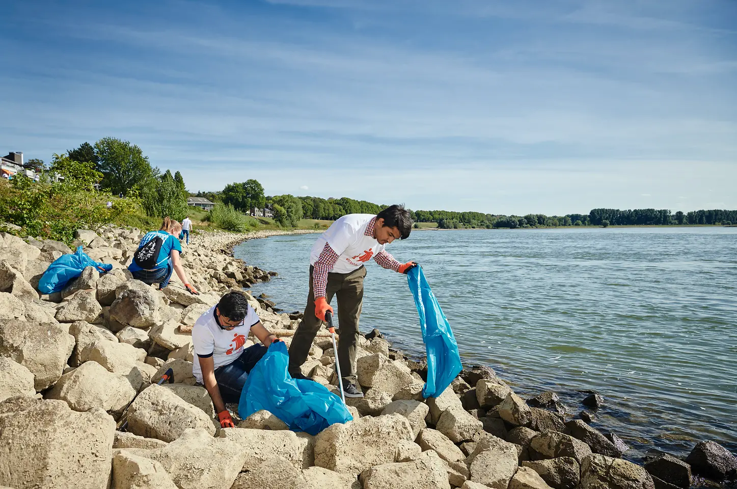Voluntarios en labores de limpieza junto al agua